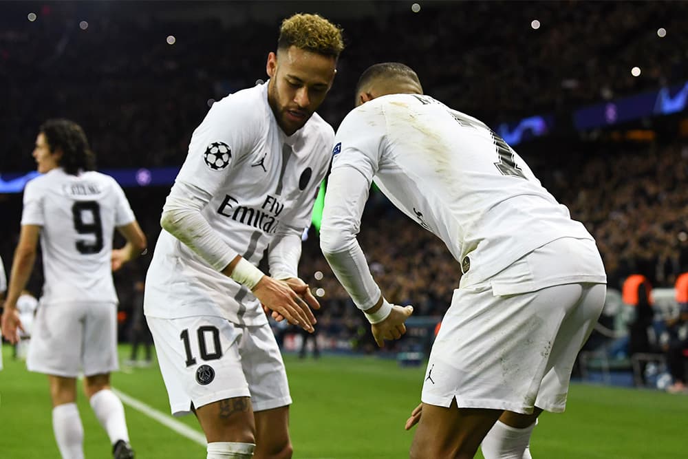 Neymar celebrates a goal for PSG with Kylian Mbappe.