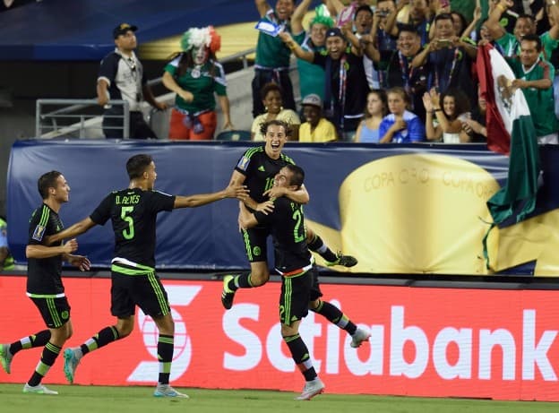 Mexico's Andres Guardado (C) celebrates his goal during the 2015 CONCACAF Gold Cup final between Jamaica and Mexico in Philadelphia on July 26, 2015. AFP PHOTO/DON EMMERT        (Photo credit should read DON EMMERT/AFP/Getty Images)