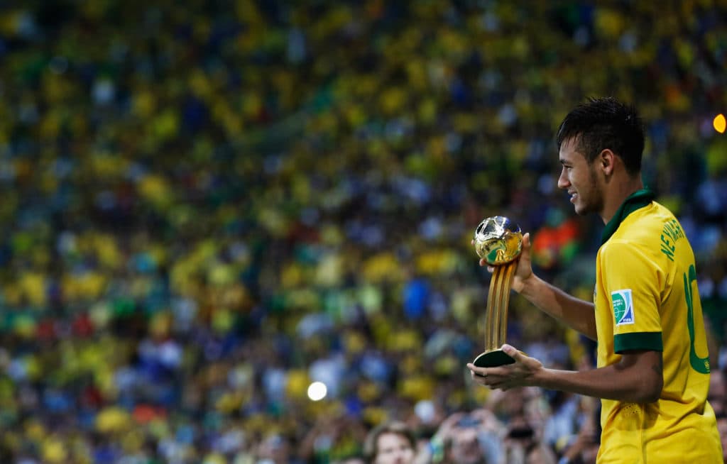 RIO DE JANEIRO, BRAZIL - JUNE 30: Neymar of Brazil celebrates with the adidas Golden Ball award after the FIFA Confederations Cup Brazil 2013 Final match between Brazil and Spain at Maracana on June 30, 2013 in Rio de Janeiro, Brazil. (Photo by Friedemann Vogel - FIFA/FIFA via Getty Images)