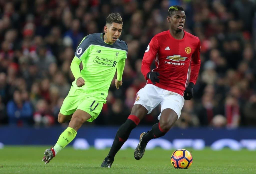 MANCHESTER, ENGLAND - JANUARY 15: Paul Pogba of Manchester United competes for the ball with Roberto Firmino of Liverpool during the Premier League match between Manchester United and Liverpool at Old Trafford on January 15, 2017 in Manchester, England. (Photo by James Baylis - AMA/Getty Images)