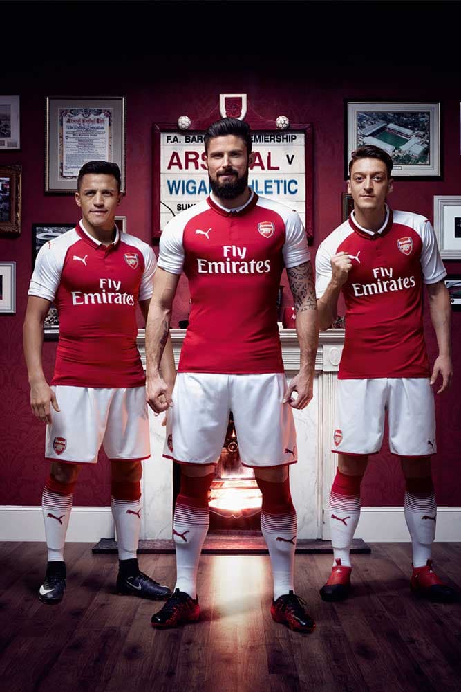 Alexis Sanchez, Olivier Giroud and Mesut Ozil in the 2017-18 PUMA Arsenal home jersey