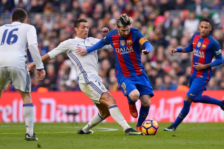 Barcelona's Argentinian forward Lionel Messi (2ndR) vies with Real Madrid's Portuguese forward Cristiano Ronaldo during the Spanish league football match FC Barcelona vs Real Madrid CF at the Camp Nou stadium in Barcelona on December 3, 2016. / AFP / JOSEP LAGO (Photo credit should read JOSEP LAGO/AFP/Getty Images)