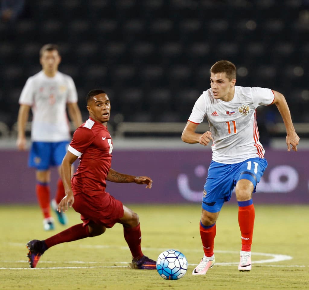 Russia's midfielder Roman Zobnin (R) dribbles past Qatar's defender Pedro Miguel Correia (L) during the International friendly match between Qatar and Russia at the Jassim Bin Hamad Stadium in Doha on November 10, 2016. / AFP / STRINGER (Photo credit should read STRINGER/AFP/Getty Images)