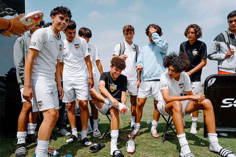 Youth players look on as a teammate trials a pair of cleats from Nike's latest Rawdacious pack.