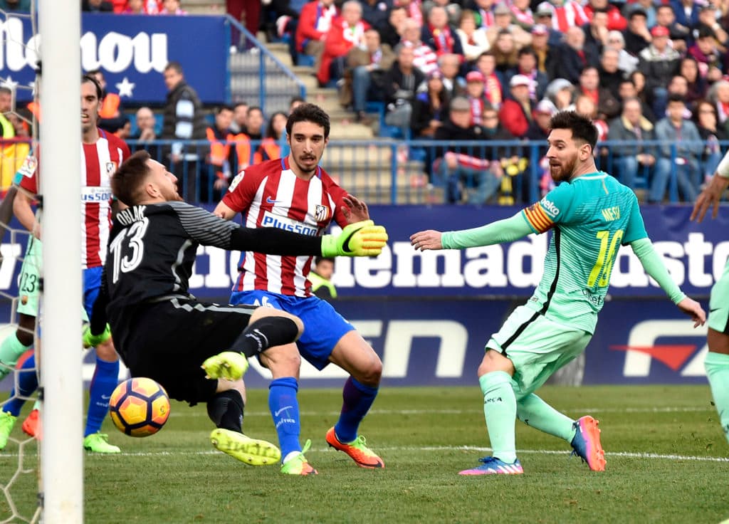 Barcelona's Argentinian forward Lionel Messi (C) scores a goal during the Spanish league football match Club Atletico de Madrid vs FC Barcelona at the Vicente Calderon stadium in Madrid on February 26, 2017. / AFP / GERARD JULIEN (Photo credit should read GERARD JULIEN/AFP/Getty Images)