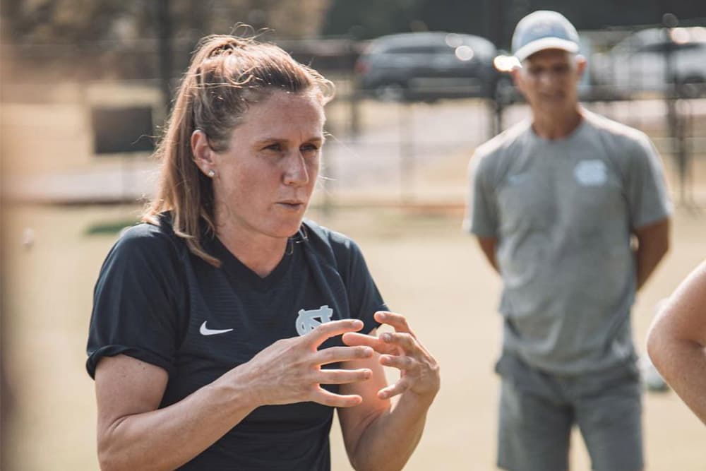 Heather O'Reilly coaching her UNC athletes on the pitch.