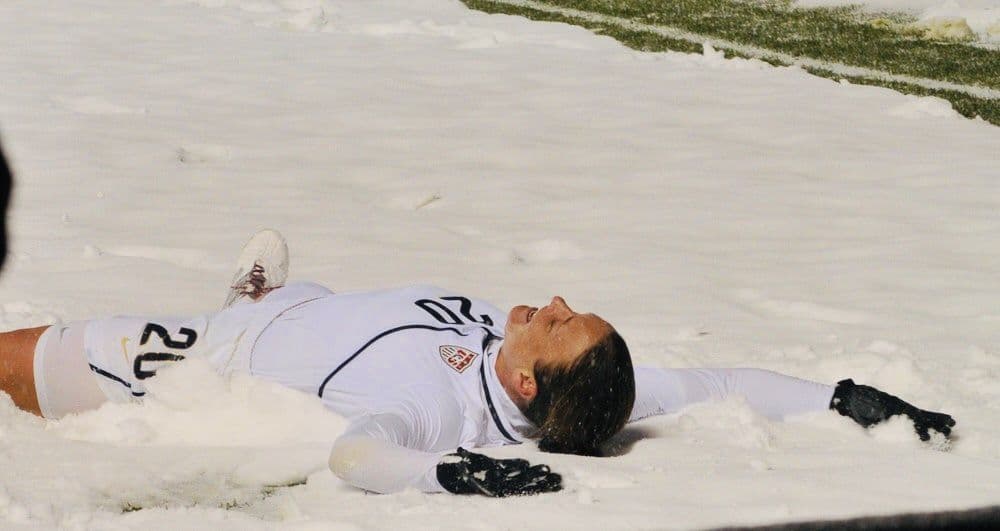 Abby Wambach celebrates a goal in the snow.