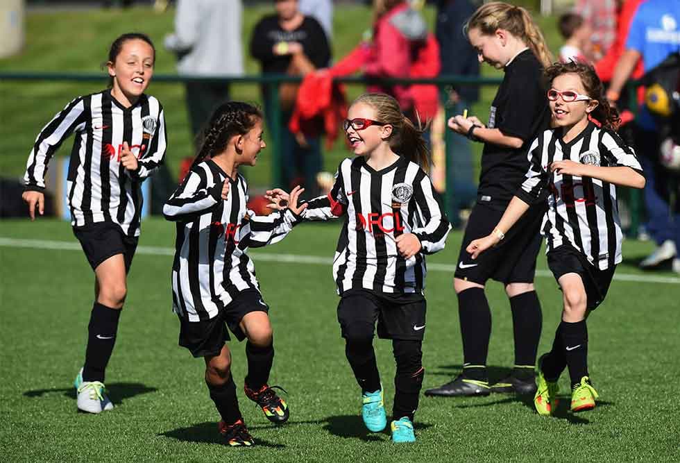 Soccer players celebrate.