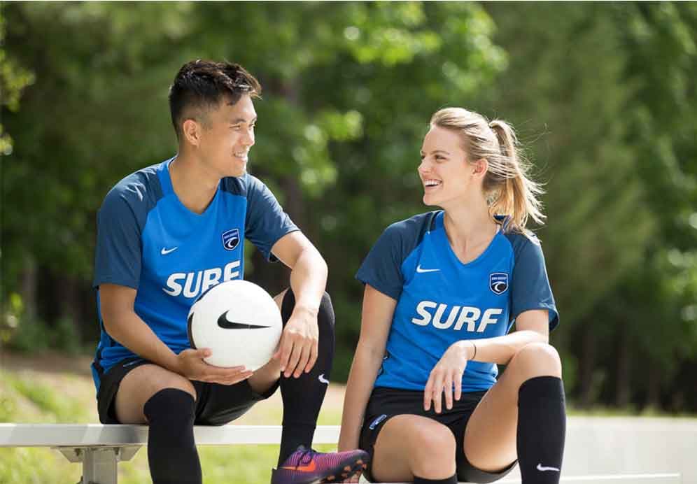 Soccer players on the sidelines.